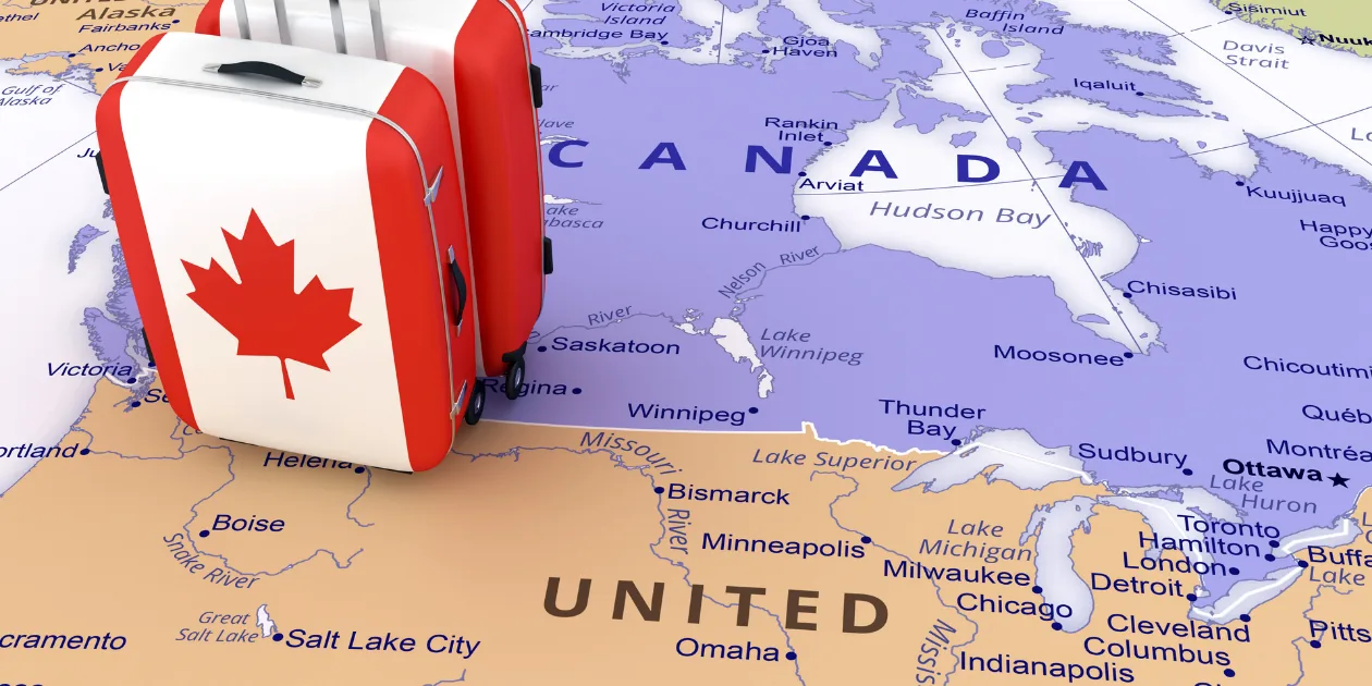 A packed suitcase on a map of Canada, representing a Canada visitor visa processing time wait