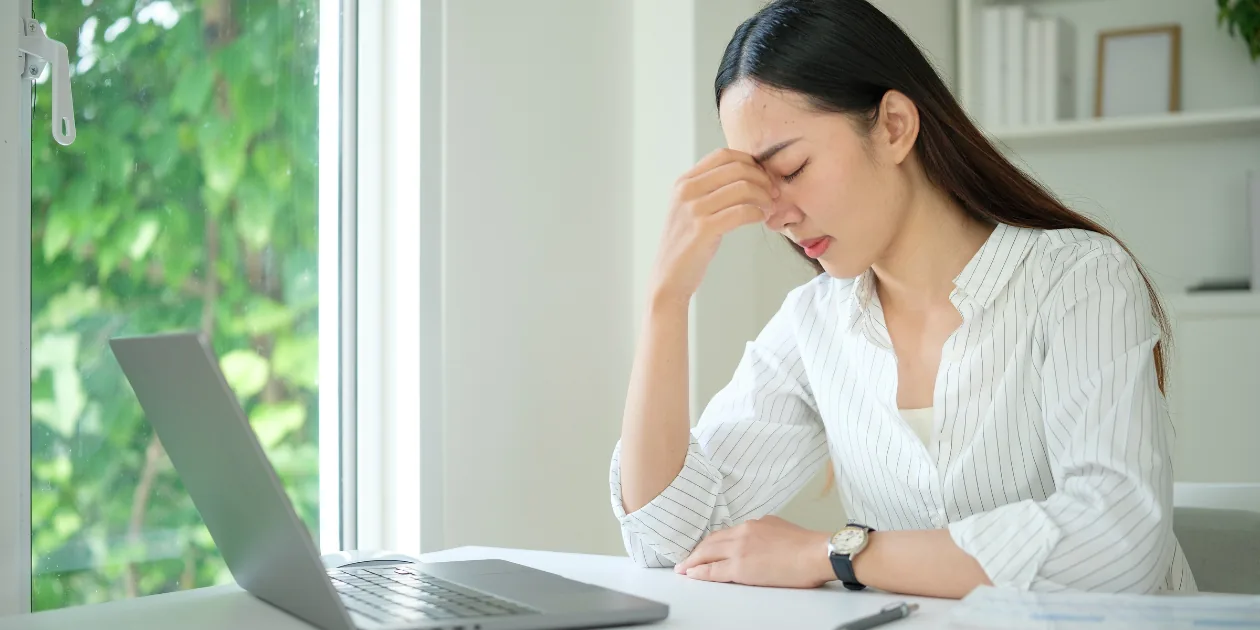A woman checking her Canada application status on a laptop while it sits in progress with no update